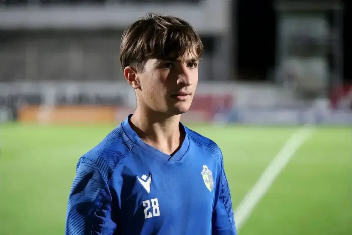 Young player in blue jersey on football field