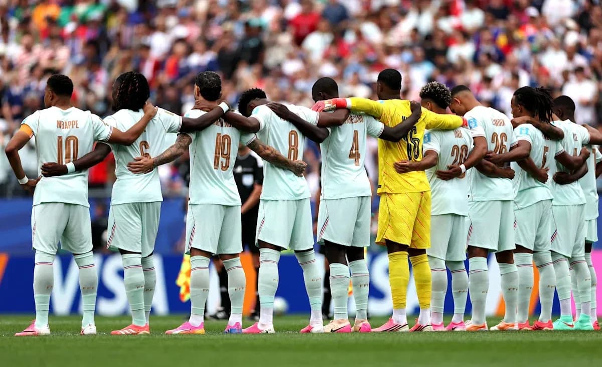 Players standing in solidarity before the match