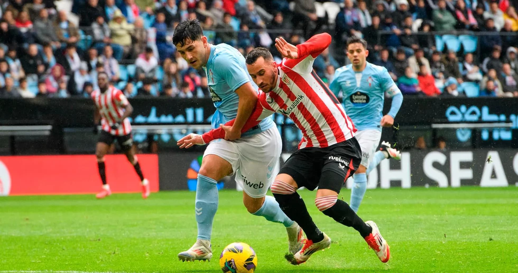 Athletic Club player challenging Celta Vigo opponent