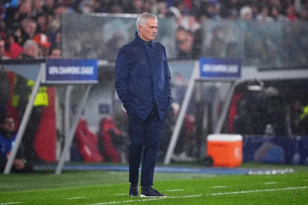 Coach observing the match in rainy conditions