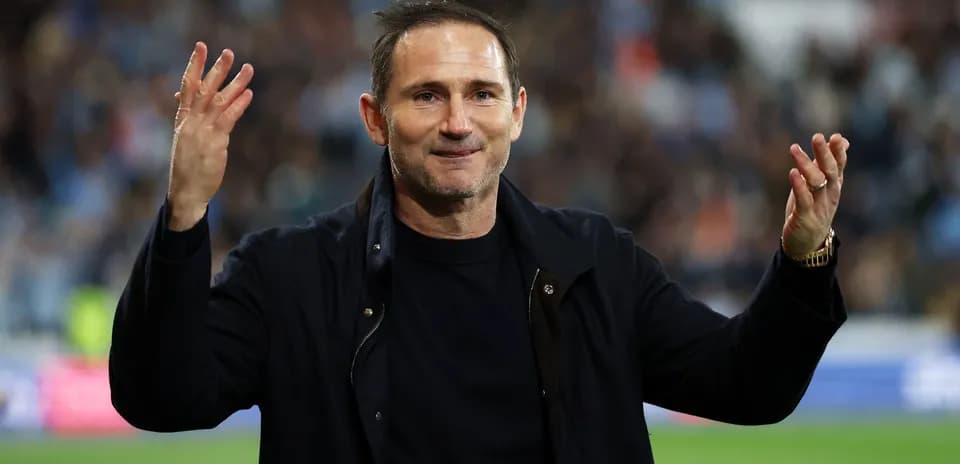 Coach gesturing towards fans during match celebration