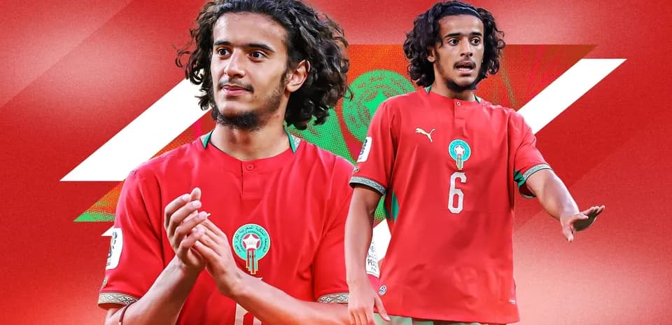 Player in red Morocco jersey gesturing on field