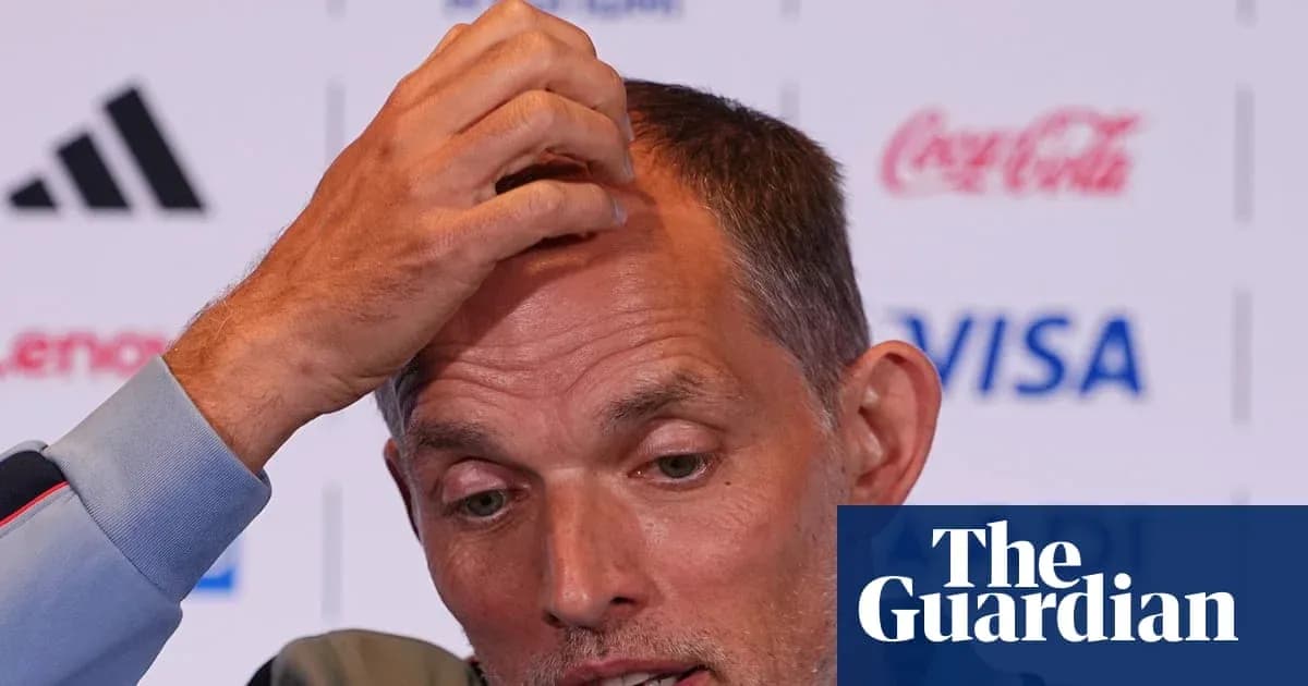 Coach speaking at press conference, hand on head