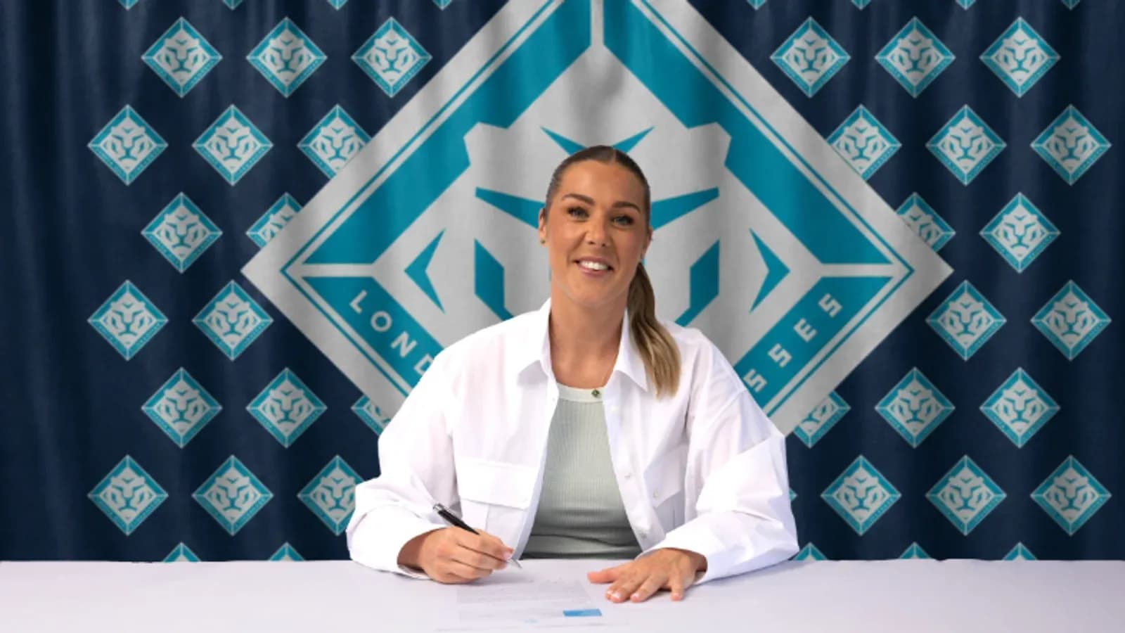 Player signing contract at promotional event
