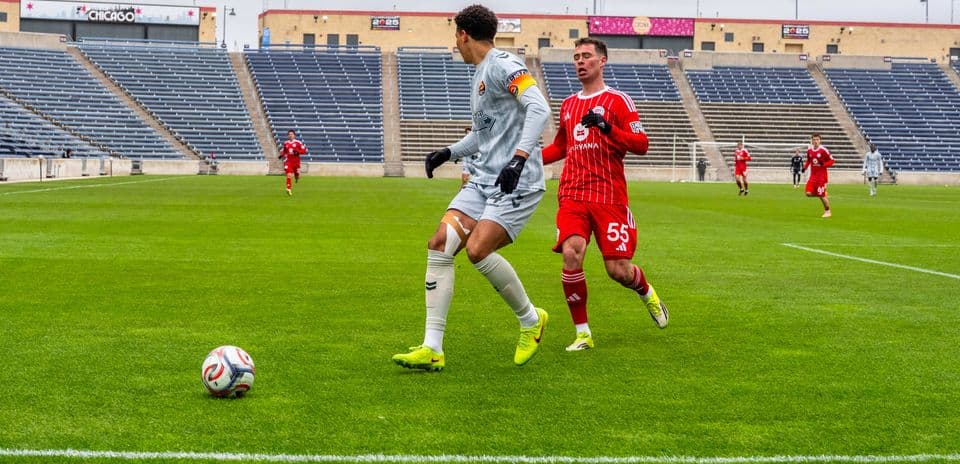 Goalkeeper and player competing for the ball