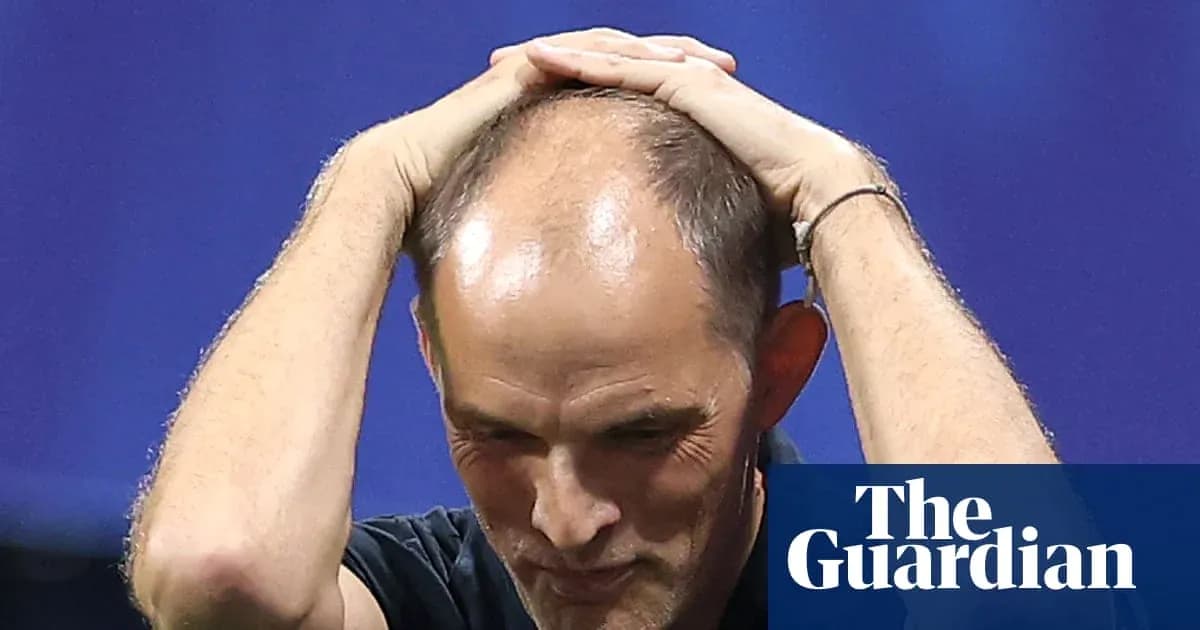 Coach holding head during tense moment