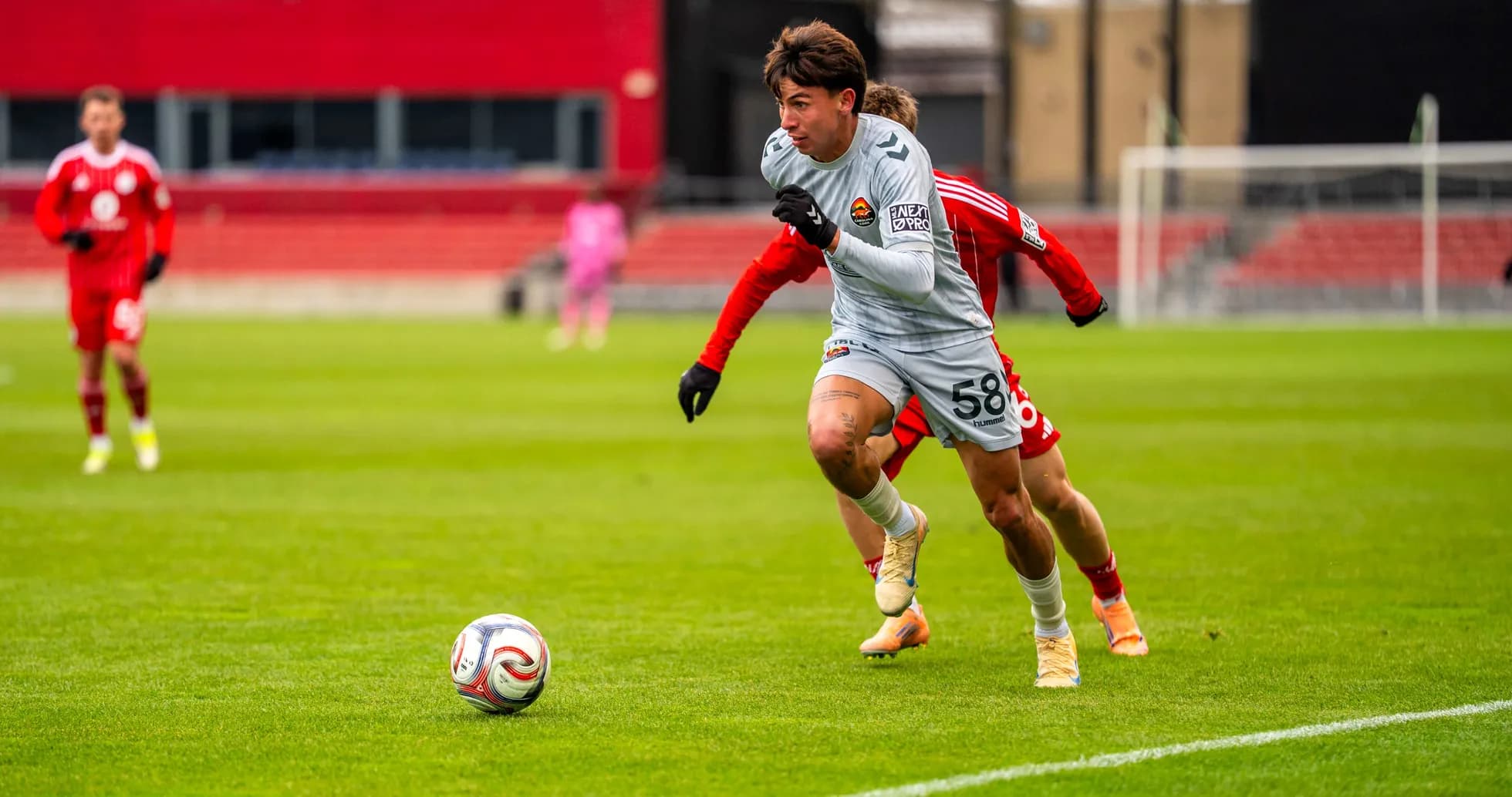 Player sprinting with the ball in a match
