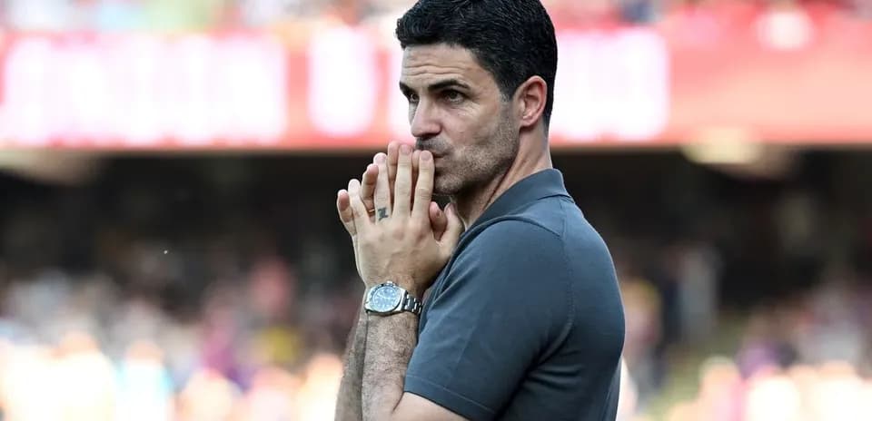 Manager observing match with hands clasped together