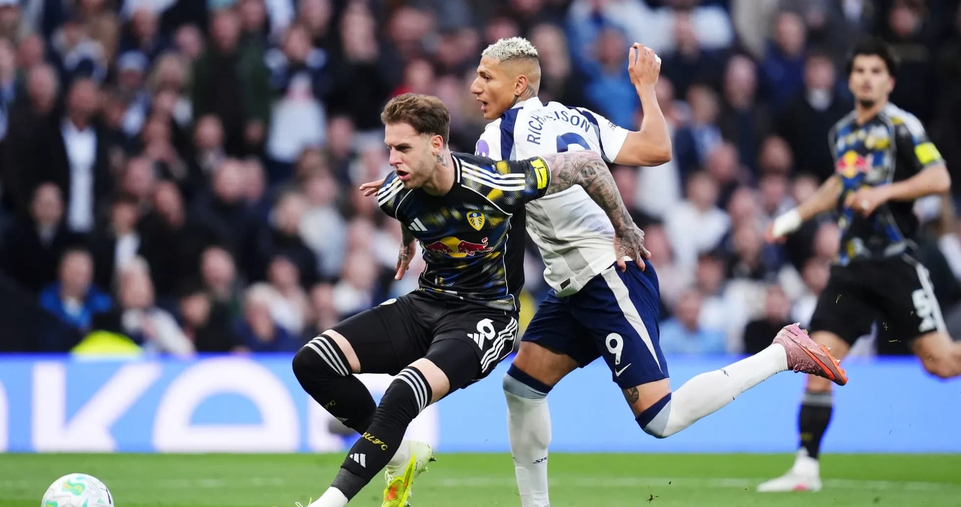 Player challenges for the ball during Tottenham vs Leeds