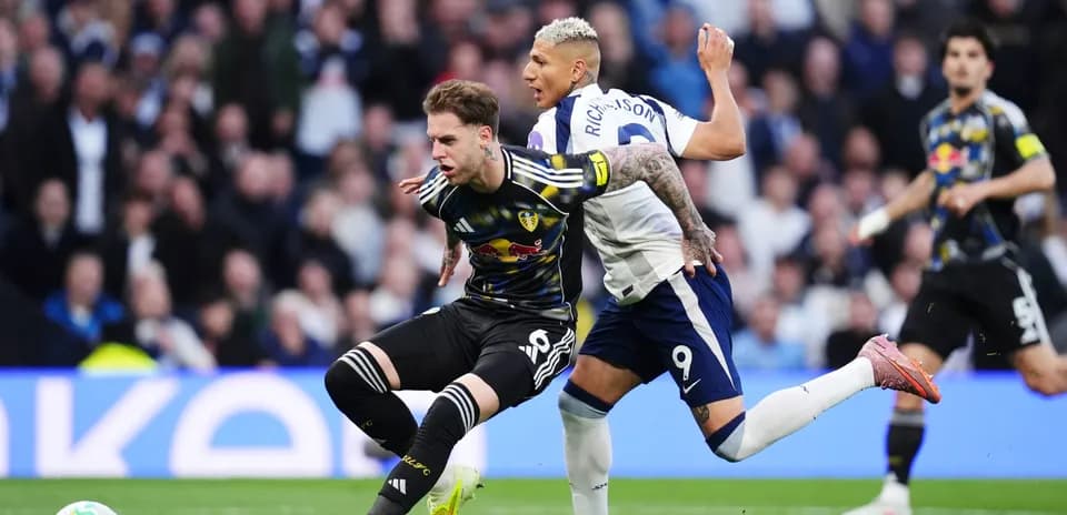Player challenges for the ball during Tottenham vs Leeds