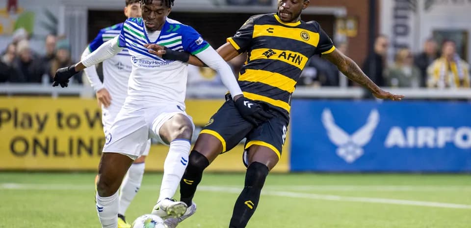 Players competing for the ball in USL Championship