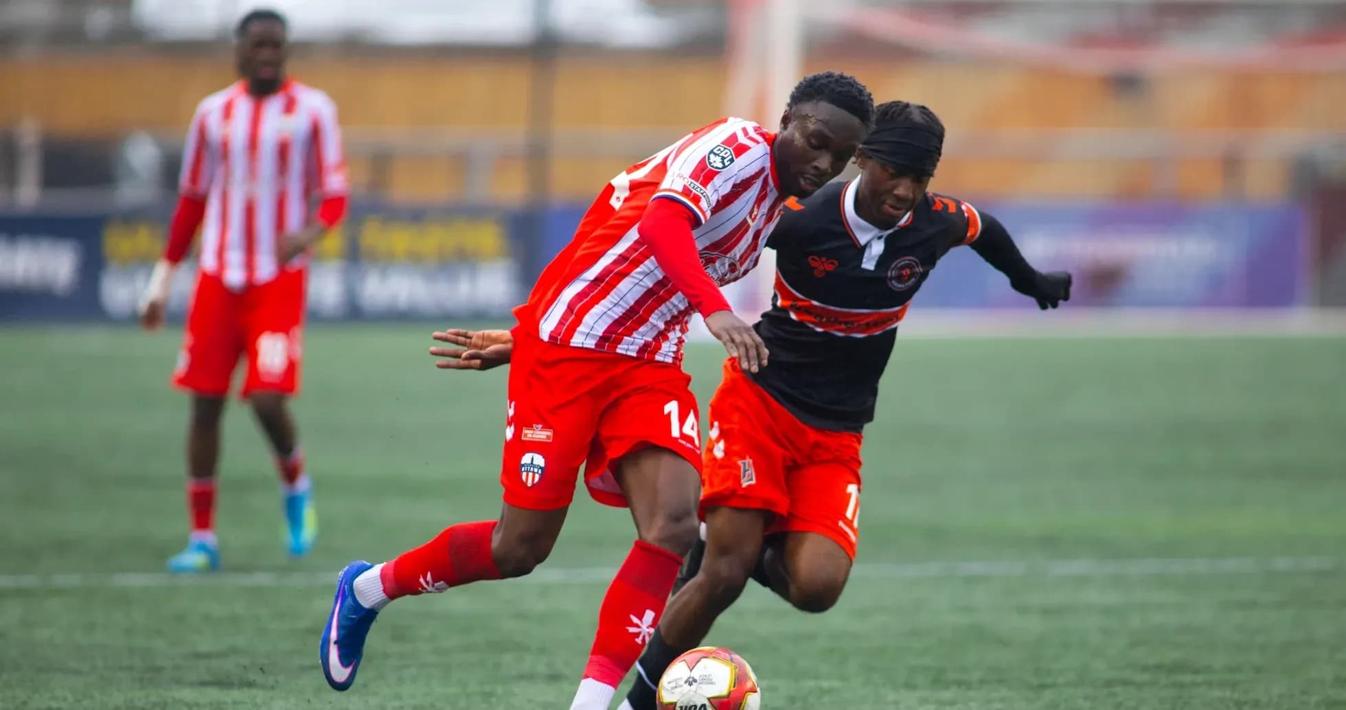 Players competing for the ball in football match