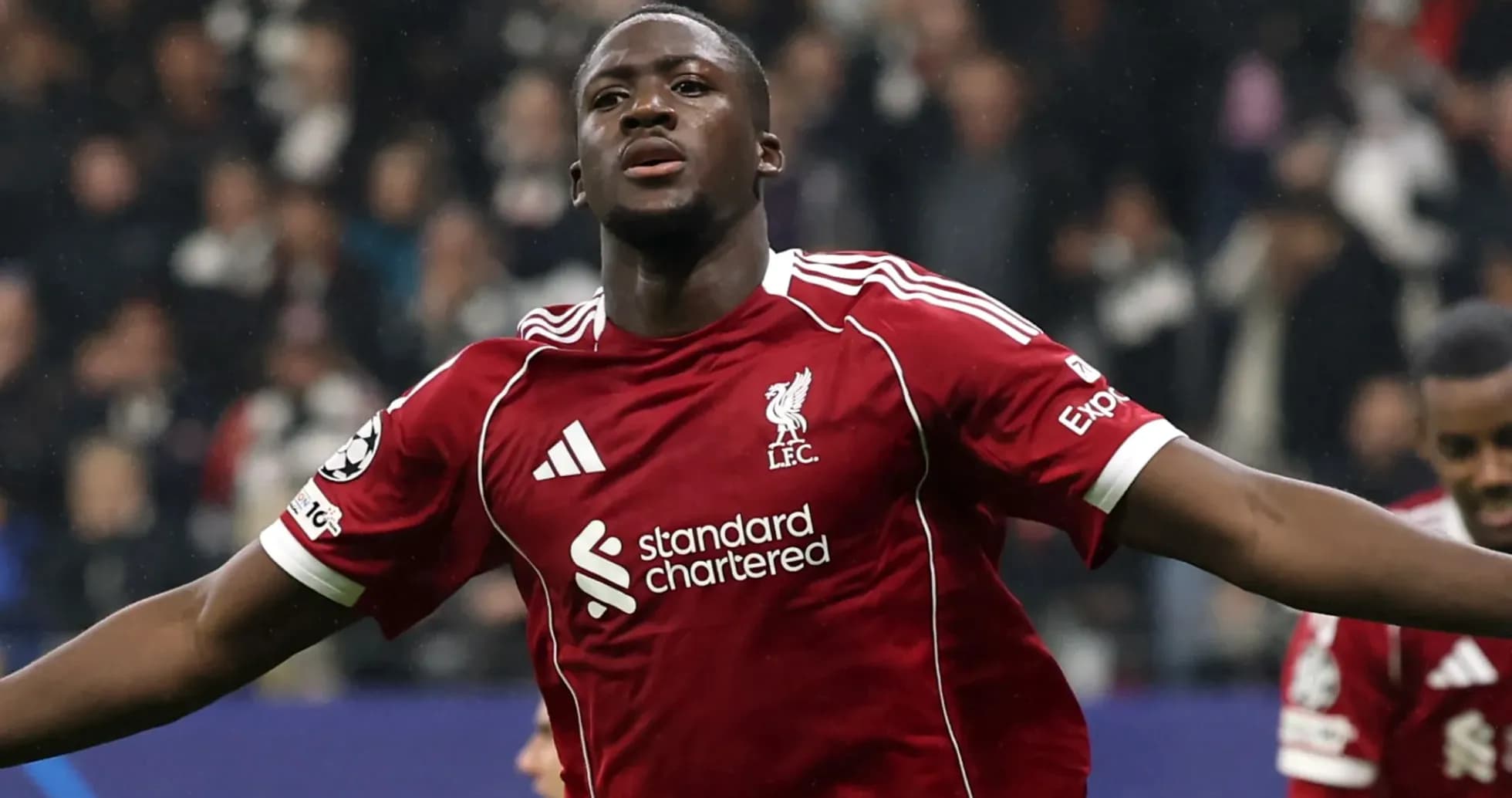 Player celebrating goal in Liverpool jersey during match