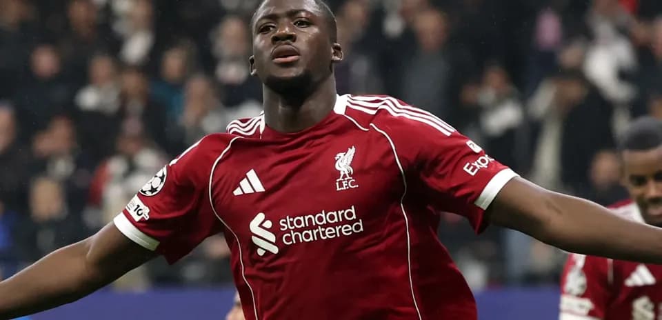 Player celebrating goal in Liverpool jersey during match