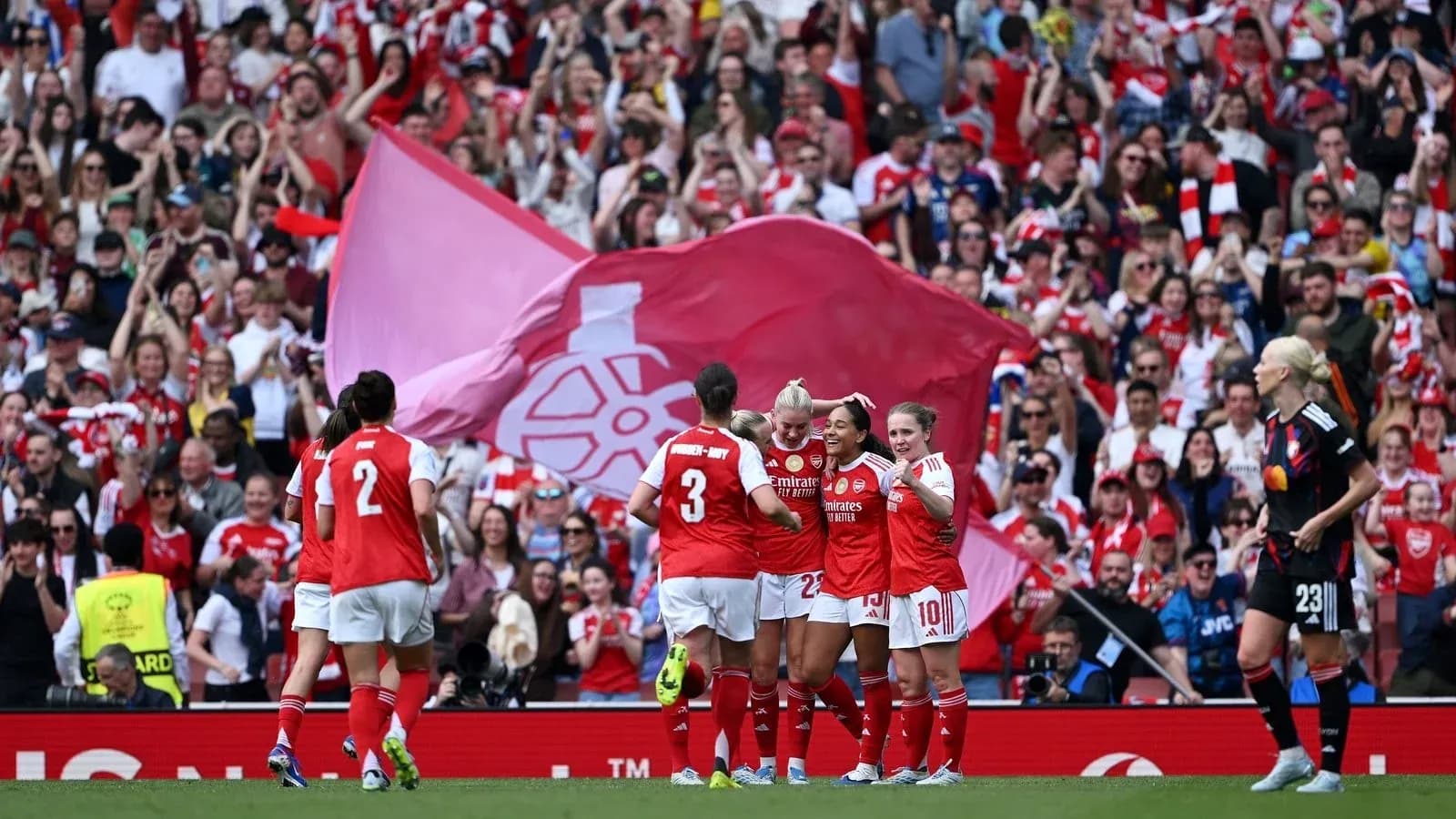 Arsenal women's team celebrating a goal with fans