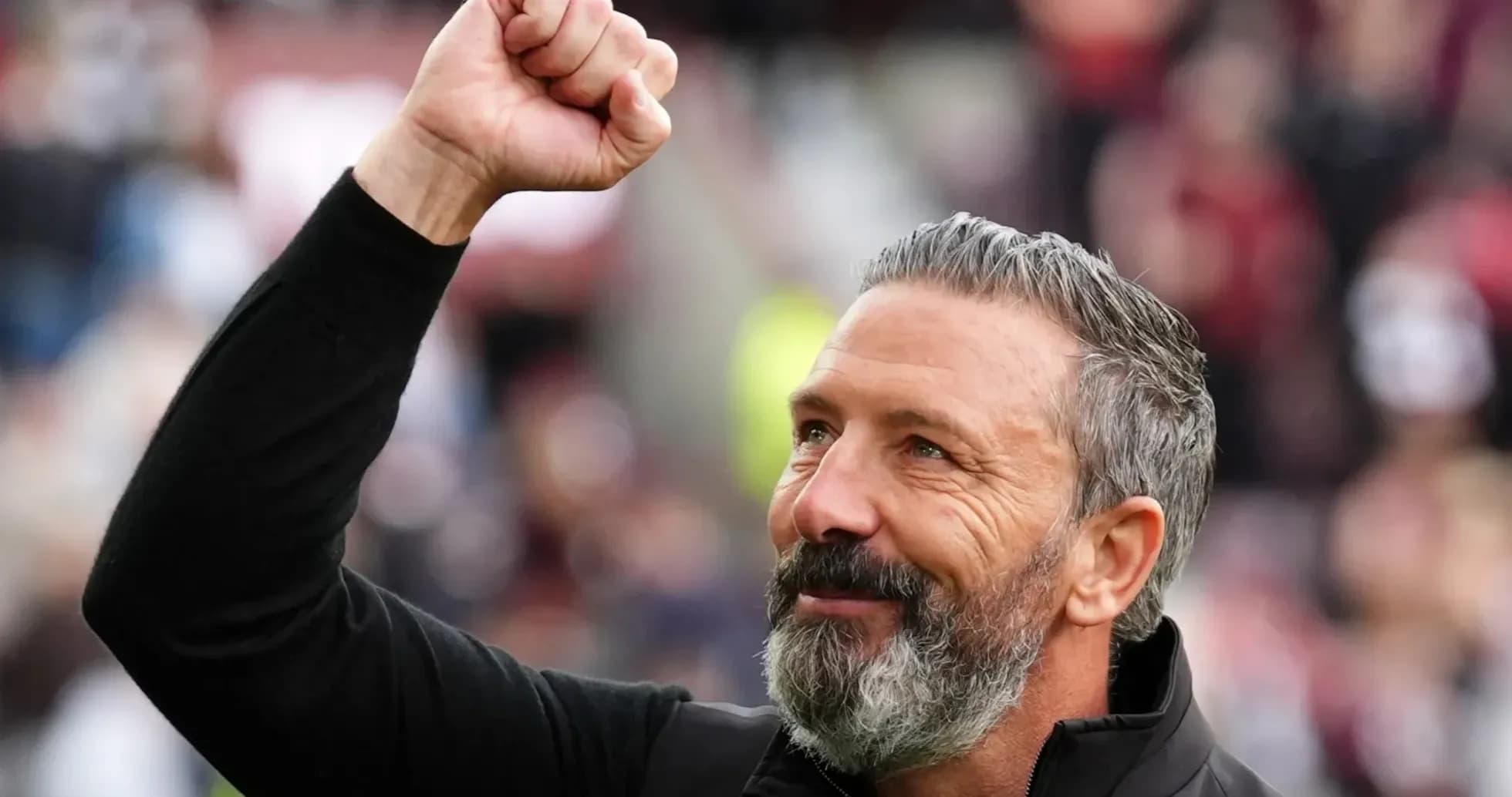 Coach celebrating with raised fist after match