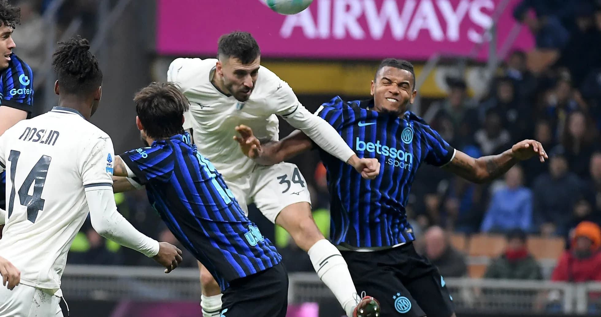 Players contesting a header during Lazio vs Inter