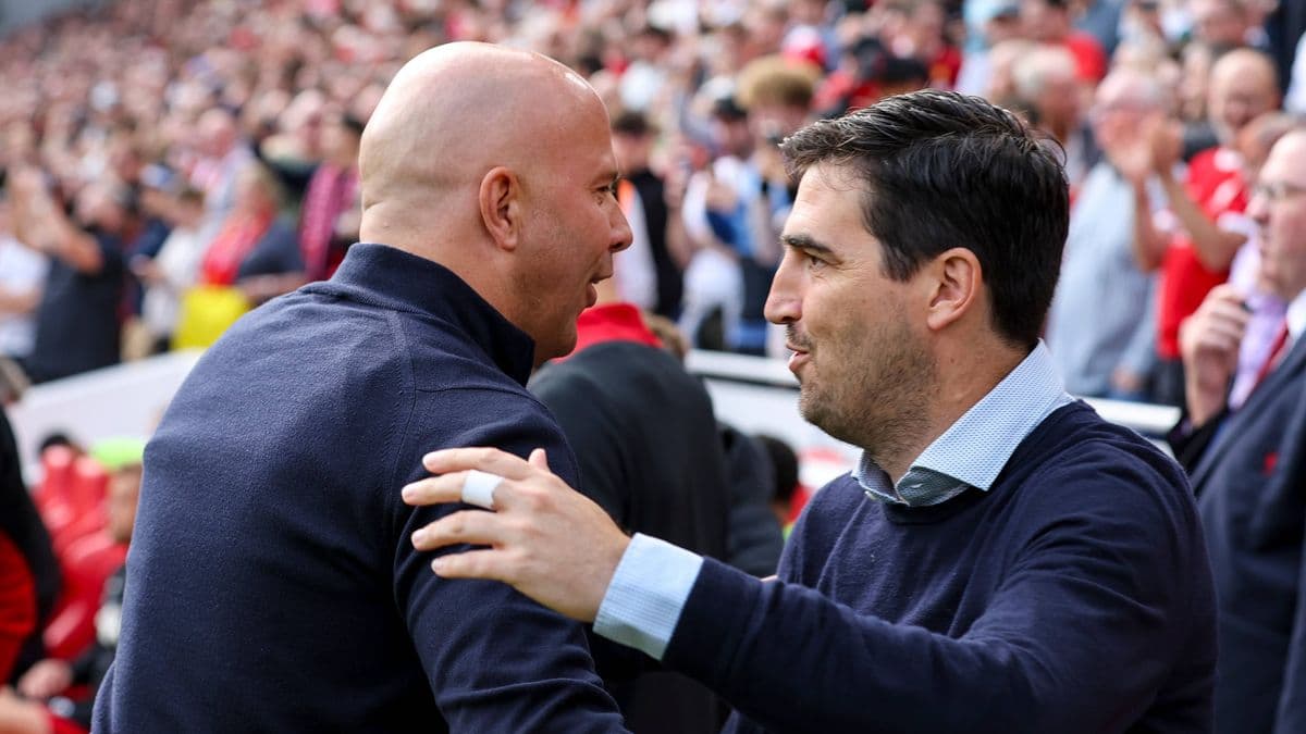 Two coaches greeting each other at the stadium