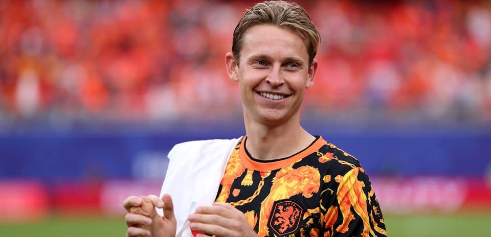 Player in vibrant shirt smiling on the field