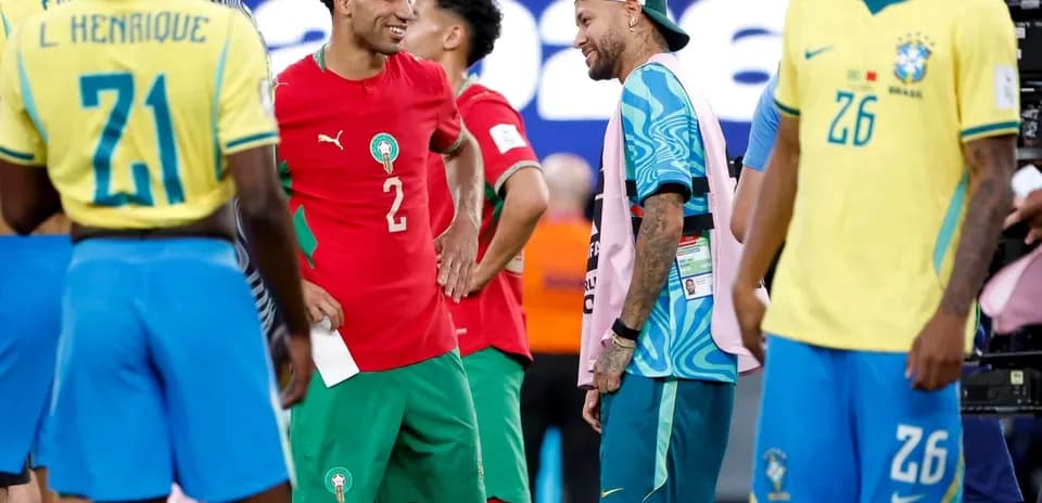 Players interacting after a match, wearing team jerseys