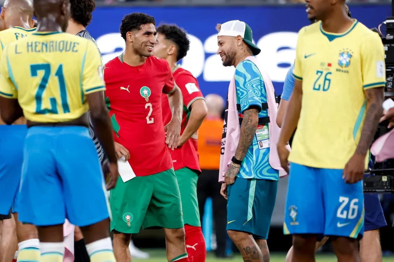 Players interacting after a match, wearing team jerseys