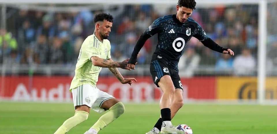 Two players competing for the ball in match