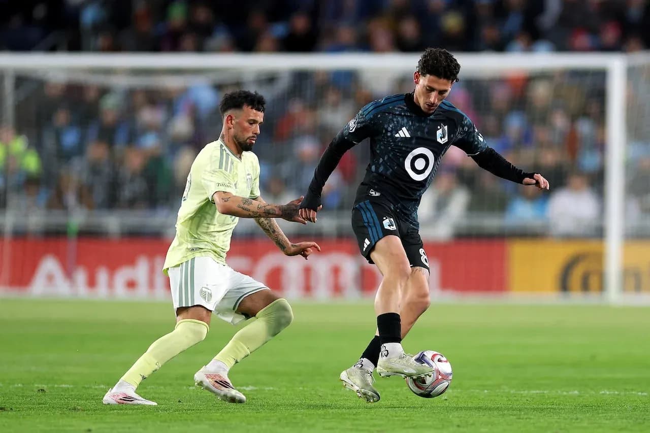 Two players competing for the ball in match
