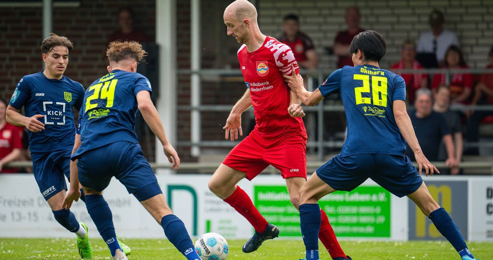 Player dribbling the ball surrounded by defenders