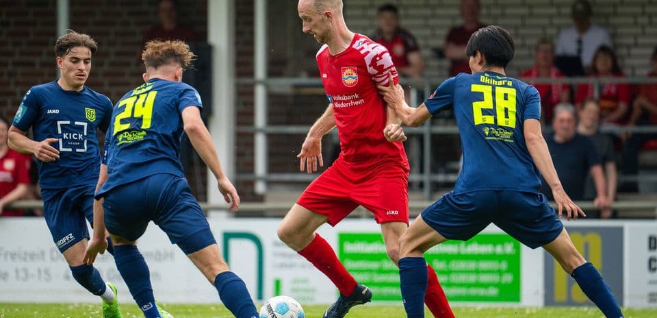 Player dribbling the ball surrounded by defenders