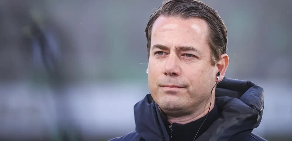 Coach wearing headphones on the sidelines