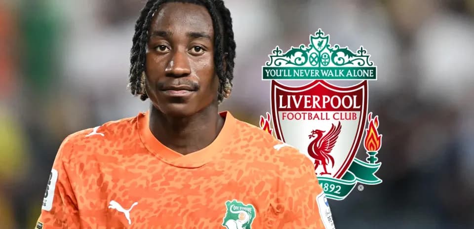 Goalkeeper in orange kit with Liverpool logo backdrop