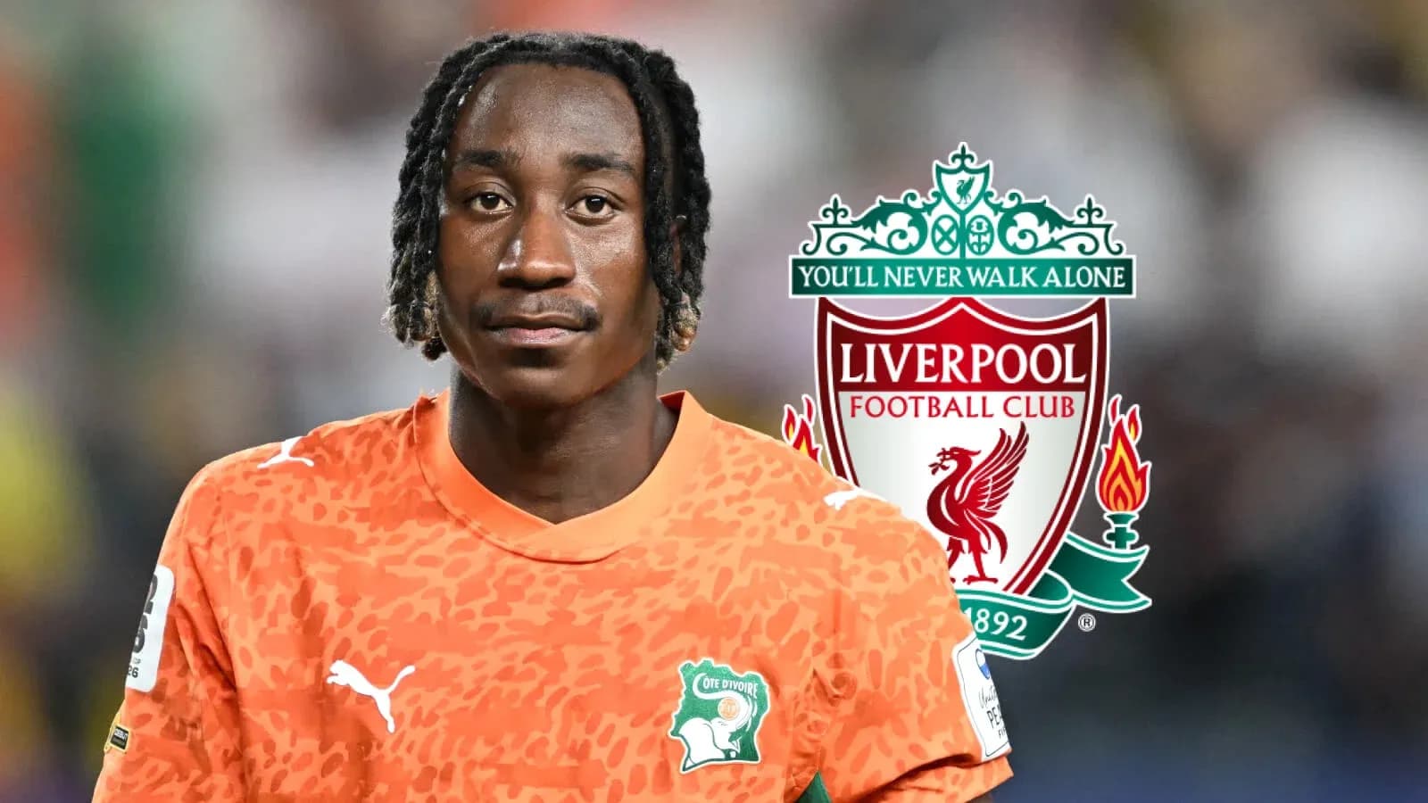 Goalkeeper in orange kit with Liverpool logo backdrop