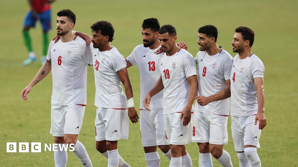 Iranian football players celebrating together on field