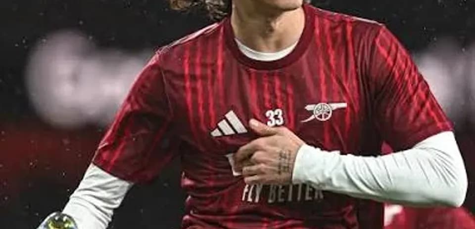Player stretching during warm-up in red jersey