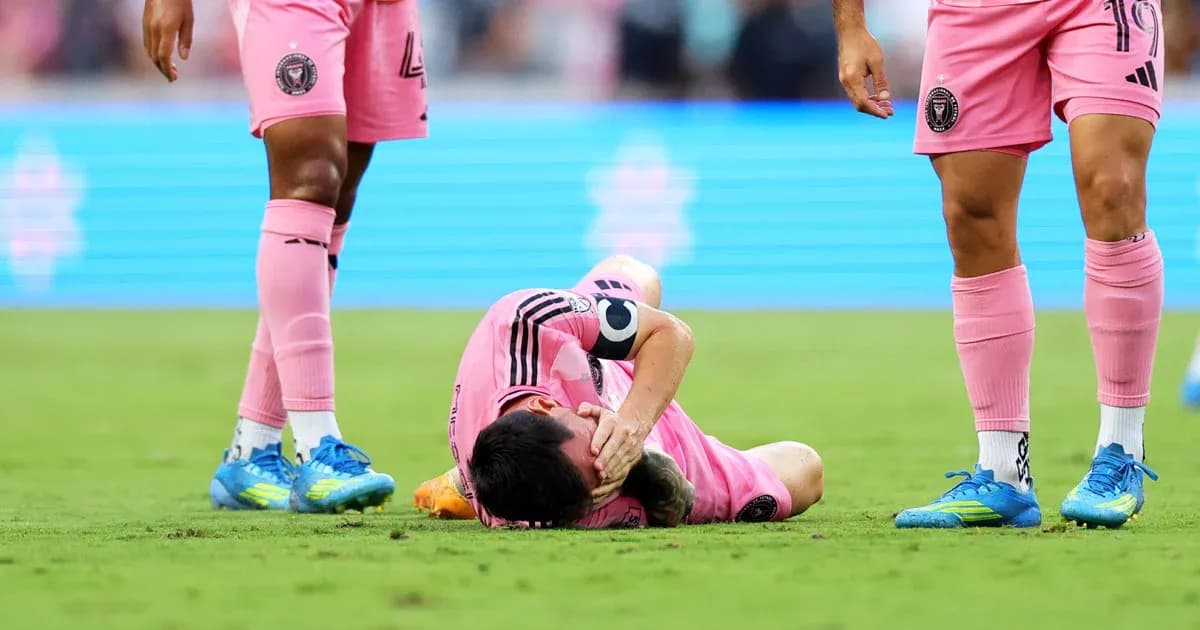 Player lying on the ground with teammates nearby