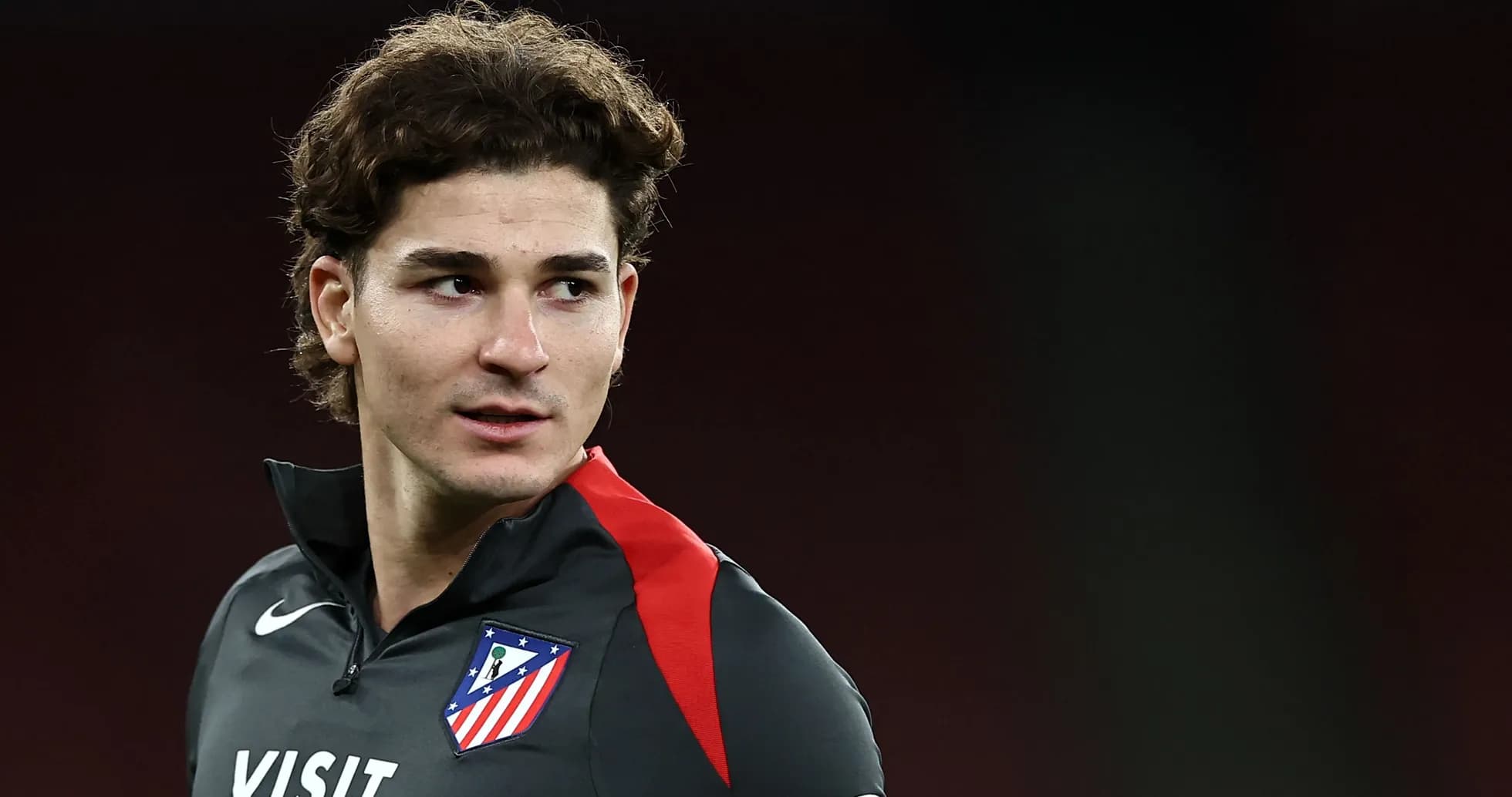 Player in Atlético Madrid training kit posing for photo