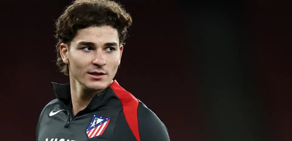 Player in Atlético Madrid training kit posing for photo