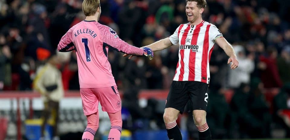 Two players celebrating on the pitch after match
