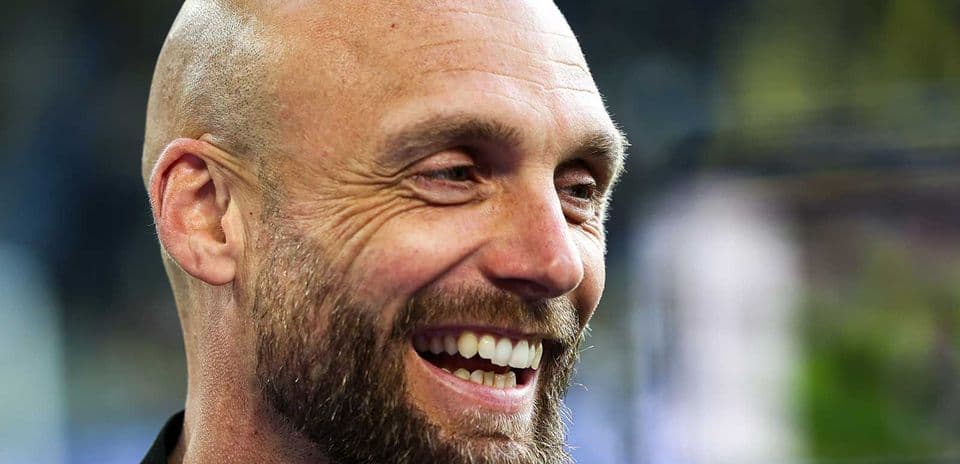 Close-up of a smiling man with a beard