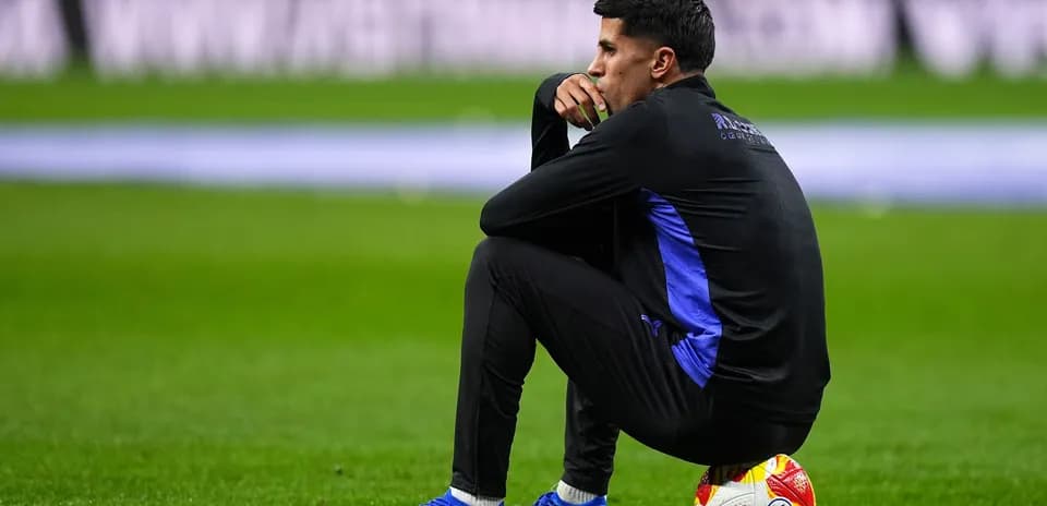 Player sitting on the field with a ball