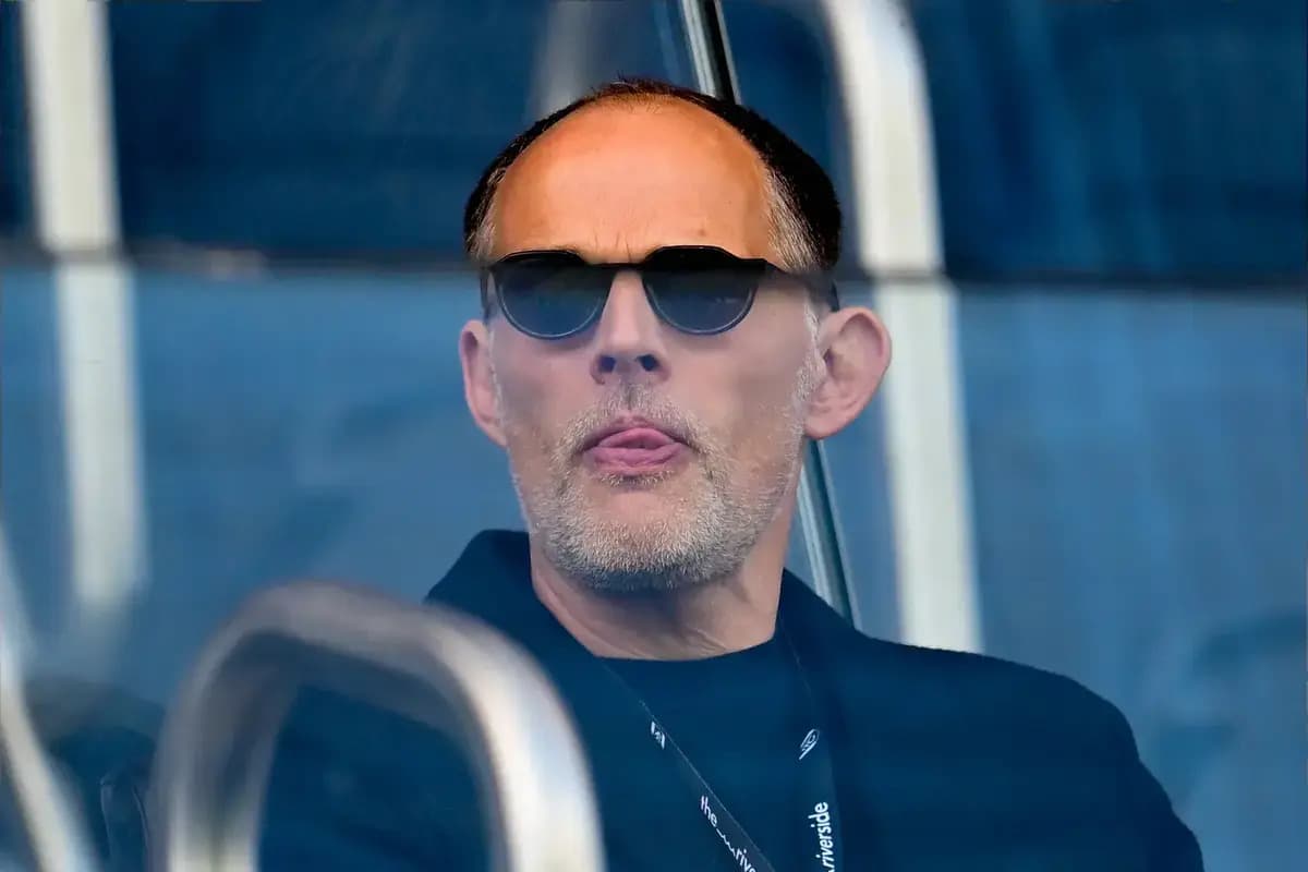 Man wearing sunglasses in a stadium box