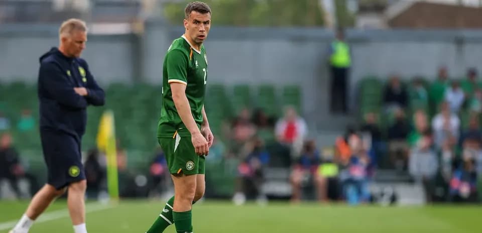 Player wearing green jersey on football pitch