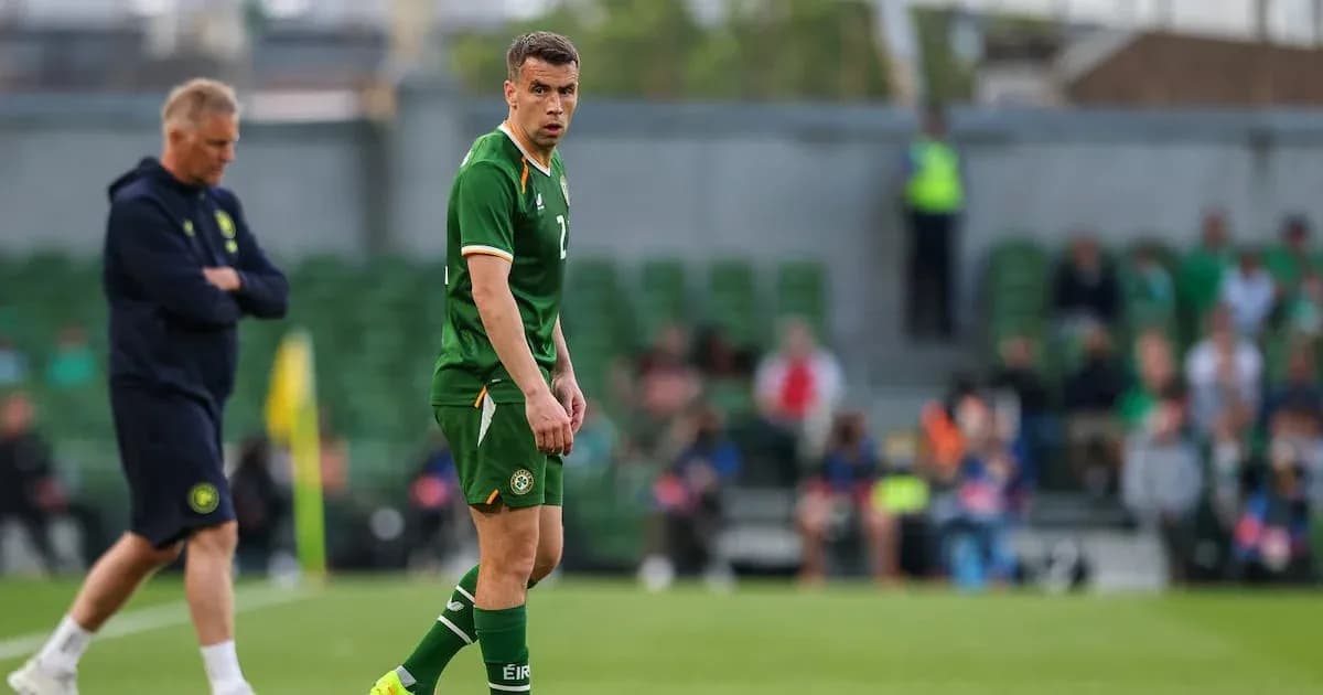 Player wearing green jersey on football pitch