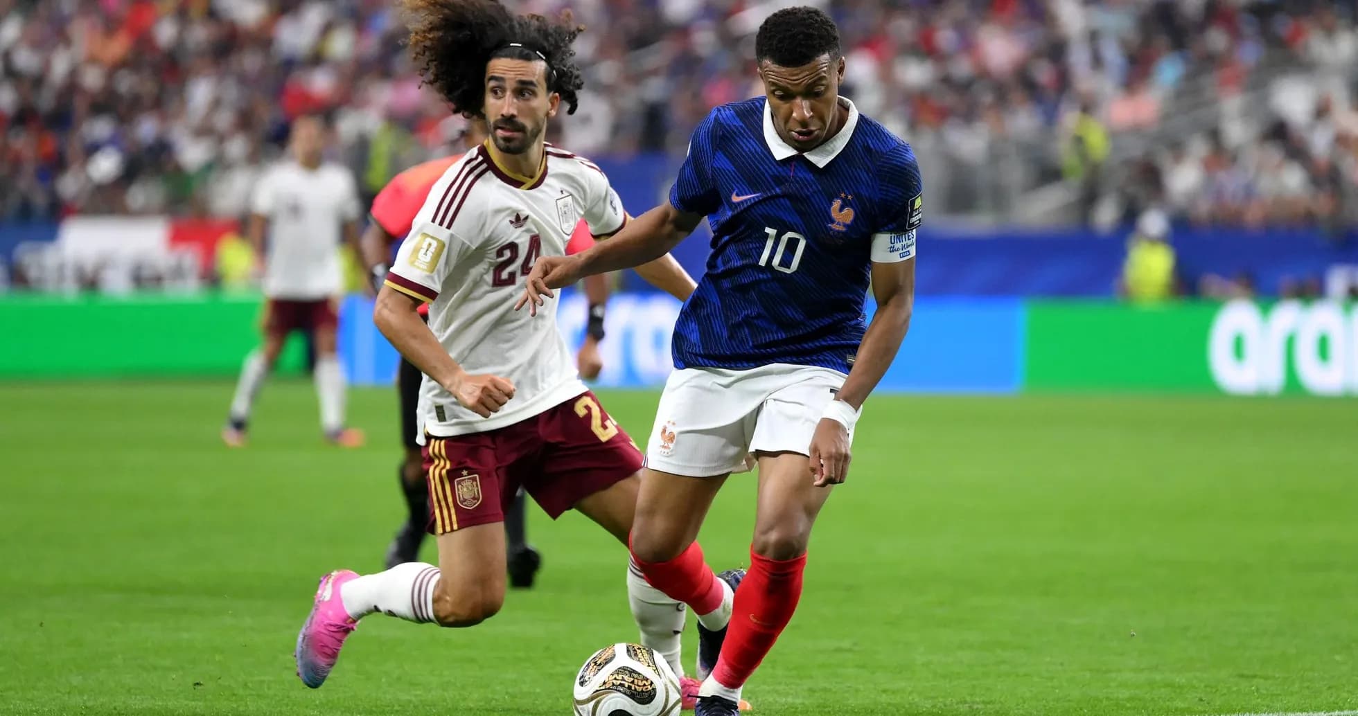 Mbappé dribbling against Spanish defender during match