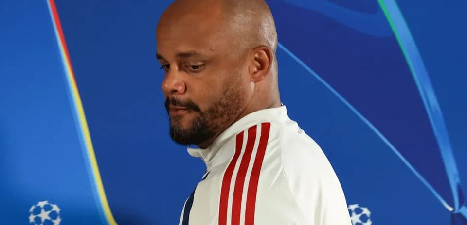 Man in sports attire during press conference backdrop