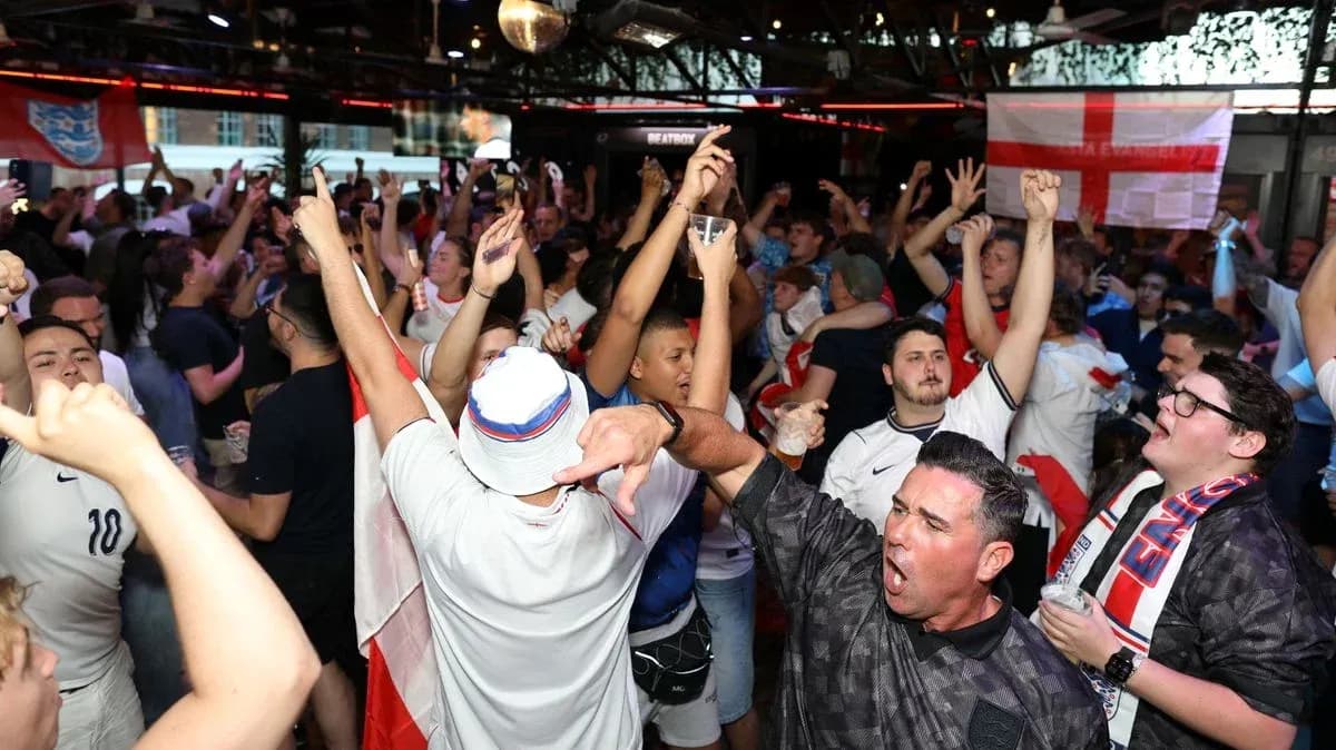 Crowd of fans celebrating in sports bar