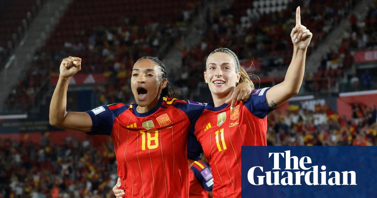 Two Spanish players celebrating a goal together