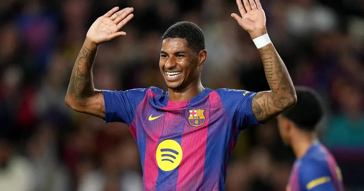 Player celebrating with raised hands on the pitch