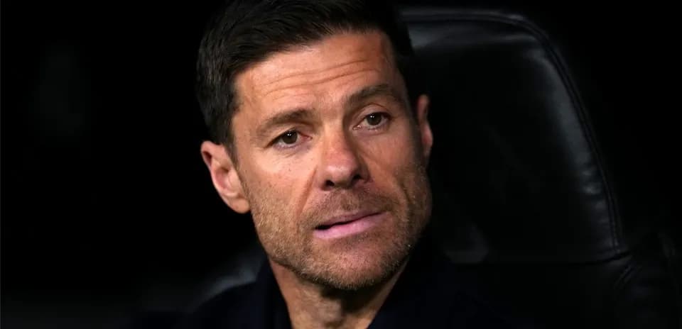 Manager seated on bench during a match