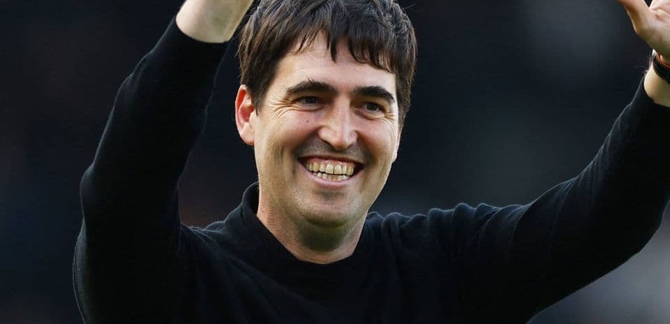 Coach waving to fans during match celebration